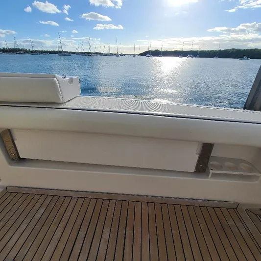 Blue Meridian Yacht Photos Pics 2003 Tiara Yachts 3800 Open, teak deck, serene waterfront view.