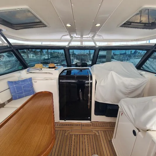 Blue Meridian Yacht Photos Pics Interior of 2003 Tiara Yachts 3800 Open with wood accents and seating.