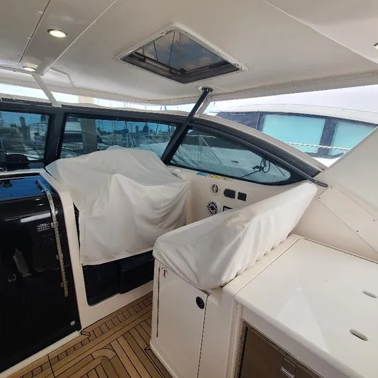 Blue Meridian Yacht Photos Pics 2003 Tiara Yachts 3800 Open interior with covered seating and helm, showcasing luxury design.