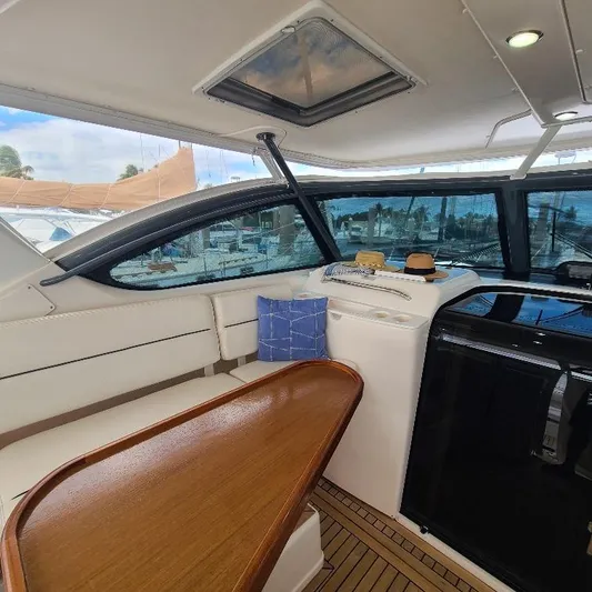 Blue Meridian Yacht Photos Pics Interior of 2003 Tiara Yachts 3800 Open, featuring seating and wooden table.