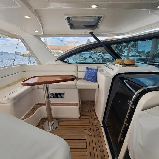 Blue Meridian Yacht Photos Pics Interior of 2003 Tiara Yachts 3800 Open with seating and wooden table.