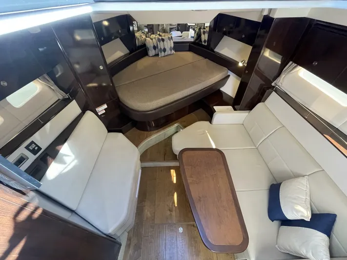Tin Cup Chalice Yacht Photos Pics 2019 Sea Ray Sundancer 350 Coupe interior with elegant seating and wooden table.