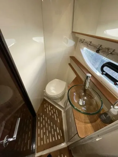 Tin Cup Chalice Yacht Photos Pics 2019 Sea Ray Sundancer 350 Coupe bathroom with modern fixtures and wooden accents.