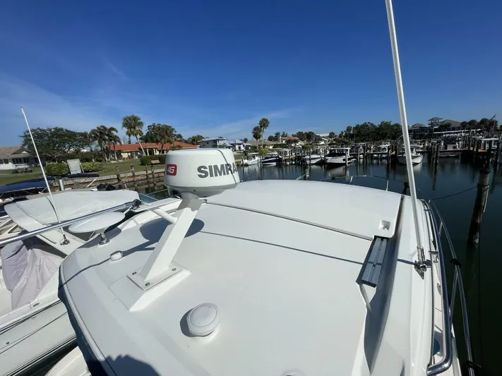 Tin Cup Chalice Yacht Photos Pics 2019 Sea Ray Sundancer 350 Coupe docked, featuring Simrad radar, under clear blue sky.