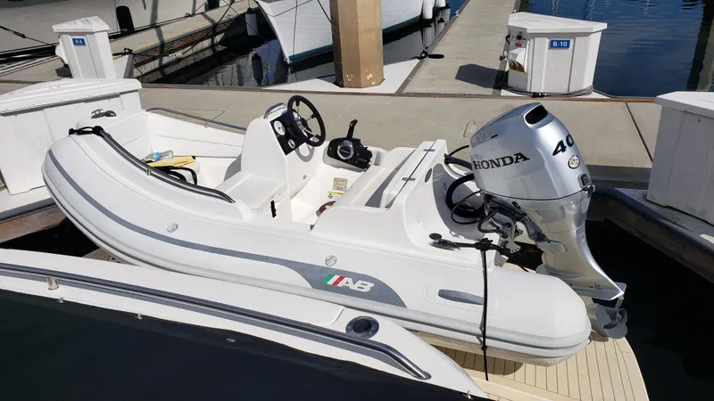 Pacific Dancer Yacht Photos Pics Inflatable boat with Honda outboard motor docked near Sea Ray 550 Sundancer, 2004 model.