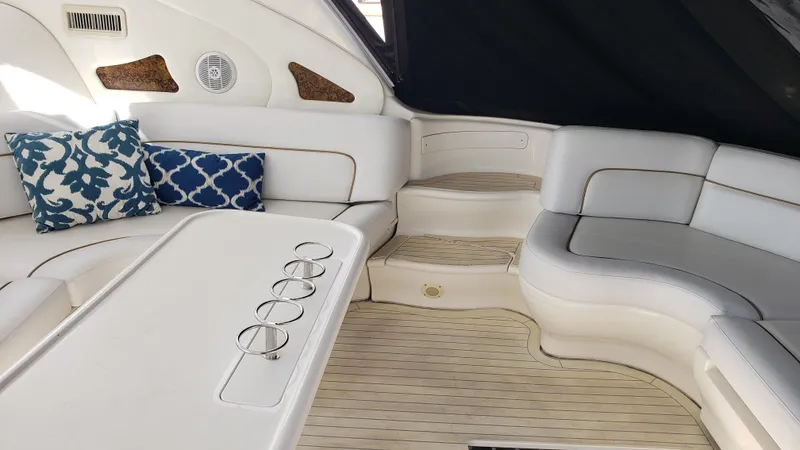 Pacific Dancer Yacht Photos Pics Luxurious interior of 2004 Sea Ray 550 Sundancer yacht with white seating and decorative pillows.