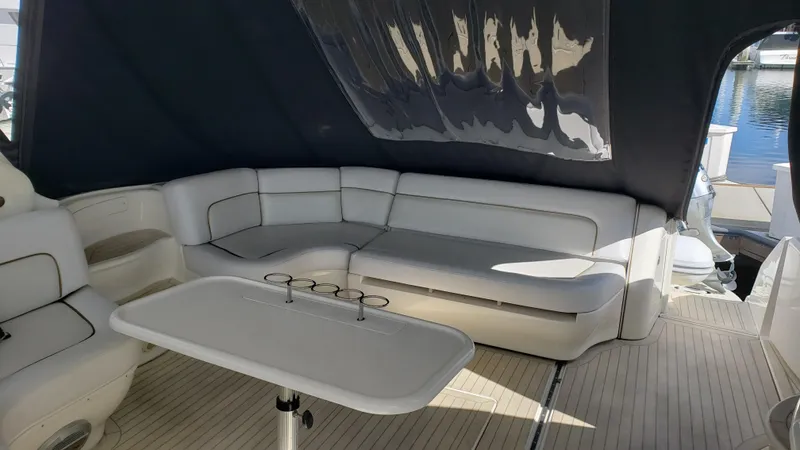 Pacific Dancer Yacht Photos Pics Luxurious 2004 Sea Ray 550 Sundancer yacht interior with white seating and table.