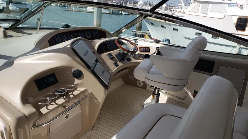 Pacific Dancer Yacht Photos Pics 2004 Sea Ray 550 Sundancer helm with luxurious seating and modern controls.