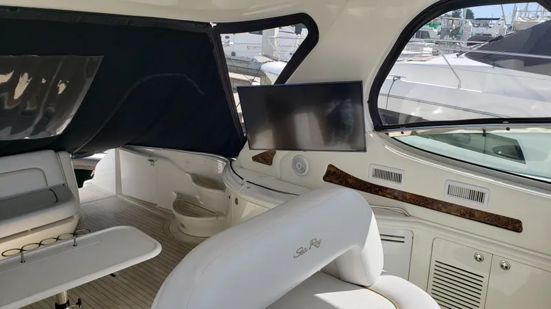 Pacific Dancer Yacht Photos Pics Interior of 2004 Sea Ray 550 Sundancer yacht with seating and mounted TV.