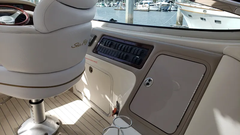 Pacific Dancer Yacht Photos Pics 2004 Sea Ray 550 Sundancer cockpit with control panel and seating, docked at marina.