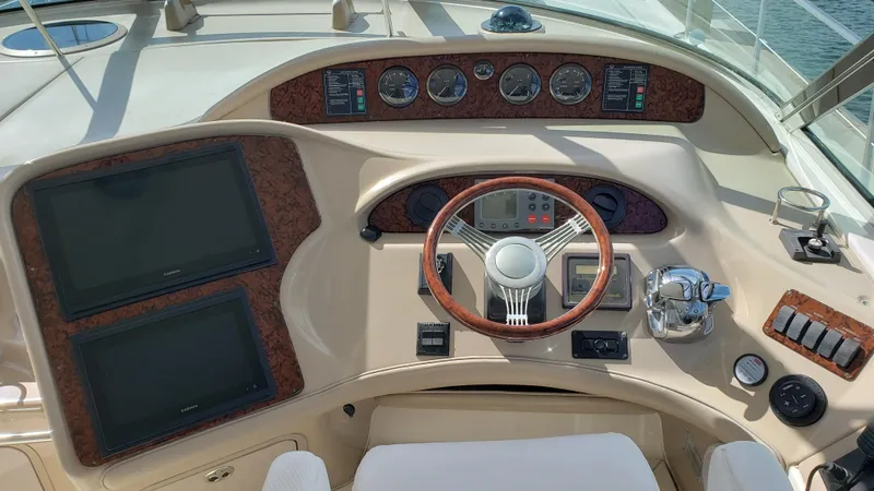 Pacific Dancer Yacht Photos Pics Helm of 2004 Sea Ray 550 Sundancer yacht with wood accents and modern controls.