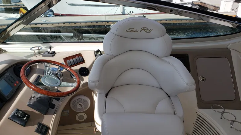 Pacific Dancer Yacht Photos Pics Luxurious helm of 2004 Sea Ray 550 Sundancer with leather seat and wooden steering wheel.