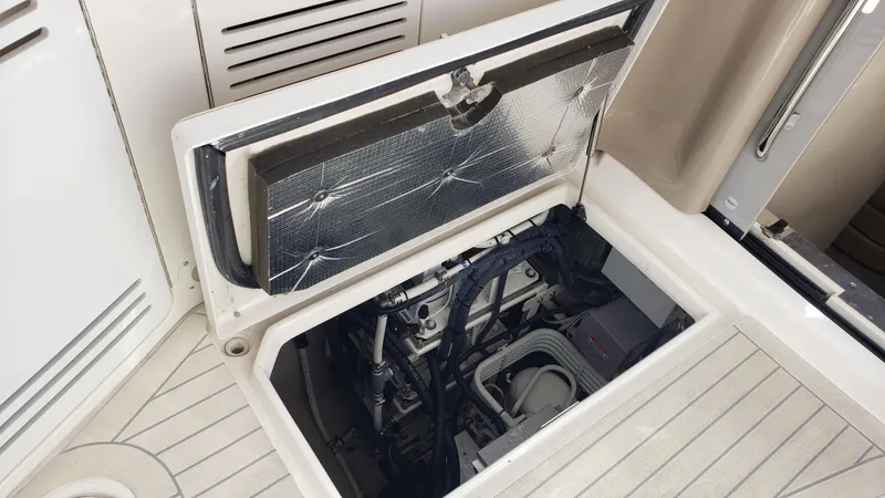 Pacific Dancer Yacht Photos Pics Open engine compartment of 2004 Sea Ray 550 Sundancer yacht, showcasing mechanical components.