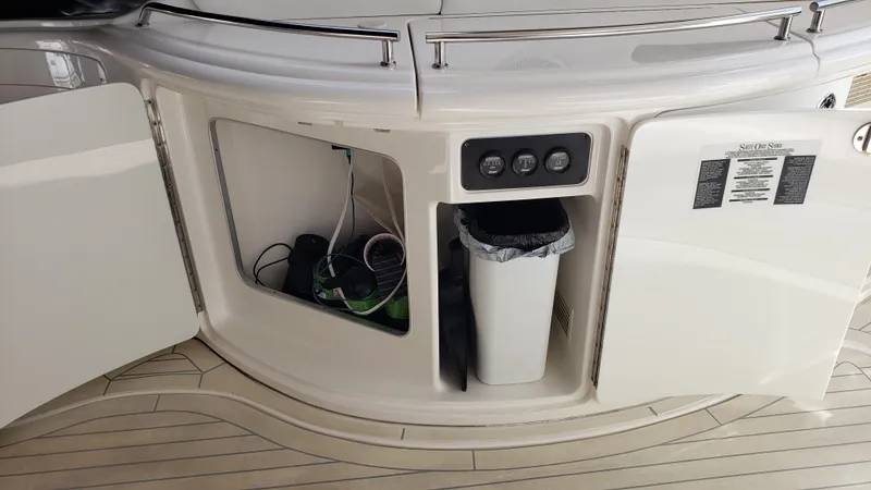 Pacific Dancer Yacht Photos Pics 2004 Sea Ray 550 Sundancer yacht interior with open storage compartments and trash bin.
