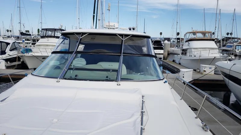 Pacific Dancer Yacht Photos Pics 2004 Sea Ray 550 Sundancer yacht docked at marina, surrounded by other boats.