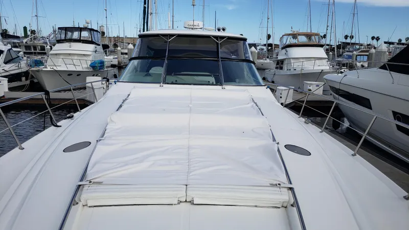 Pacific Dancer Yacht Photos Pics 2004 Sea Ray 550 Sundancer yacht docked in a marina, surrounded by other boats.