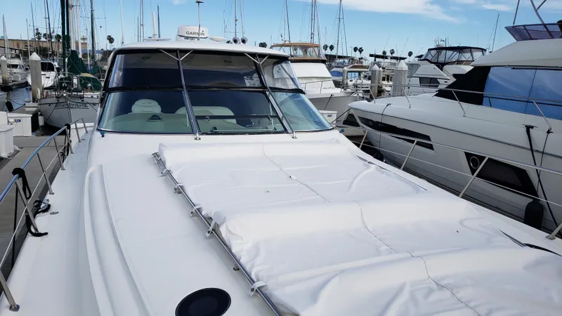 Pacific Dancer Yacht Photos Pics 2004 Sea Ray 550 Sundancer yacht docked in a marina, surrounded by other boats.