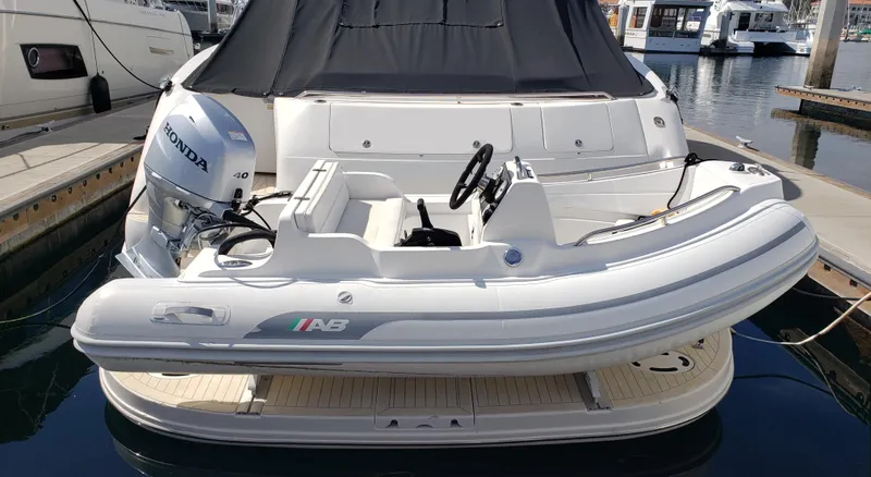 Pacific Dancer Yacht Photos Pics 2004 Sea Ray 550 Sundancer with inflatable boat and Honda outboard motor at marina.