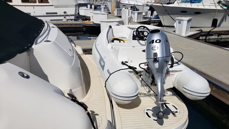 Pacific Dancer Yacht Photos Pics 2004 Sea Ray 550 Sundancer with inflatable boat and outboard motor at marina.