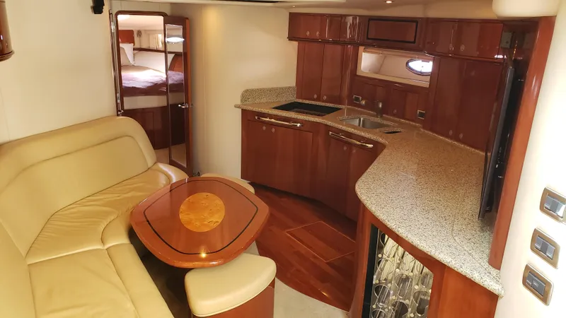 Pacific Dancer Yacht Photos Pics Luxurious interior of 2004 Sea Ray 550 Sundancer yacht with elegant wood finishes and cozy seating.