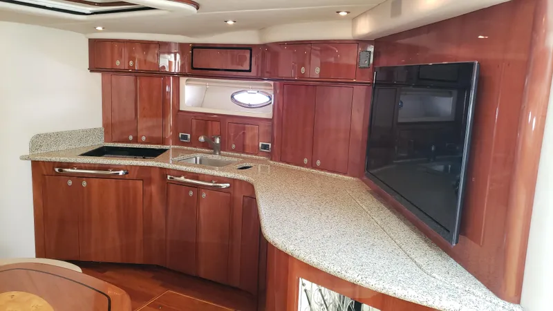 Pacific Dancer Yacht Photos Pics Luxurious interior of 2004 Sea Ray 550 Sundancer yacht with elegant wood cabinetry and modern amenities.