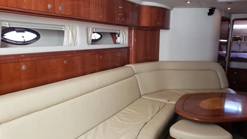 Pacific Dancer Yacht Photos Pics Luxurious interior of 2004 Sea Ray 550 Sundancer yacht with leather seating and wooden cabinetry.