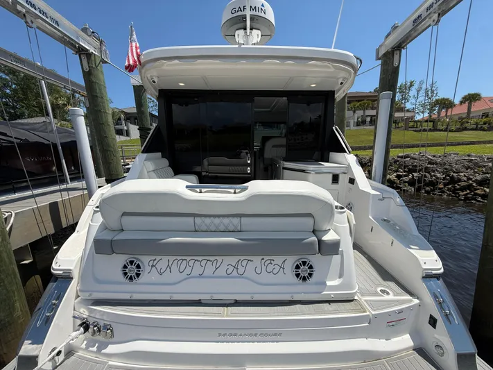  Yacht Photos Pics 2022 Regal 36 Grande Coupe yacht docked, rear view with "Knotty at Sea" text.