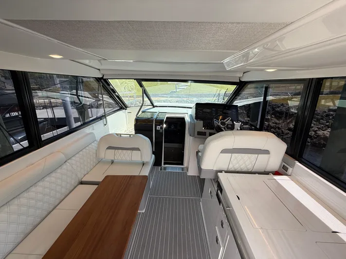  Yacht Photos Pics Interior of 2022 Regal 36 Grande Coupe, featuring luxurious seating and modern helm.