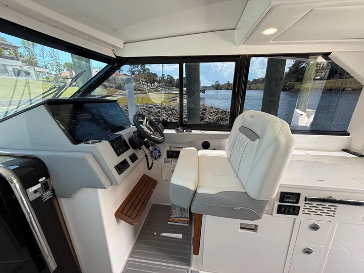  Yacht Photos Pics 2022 Regal 36 Grande Coupe helm with modern controls and comfortable seating.