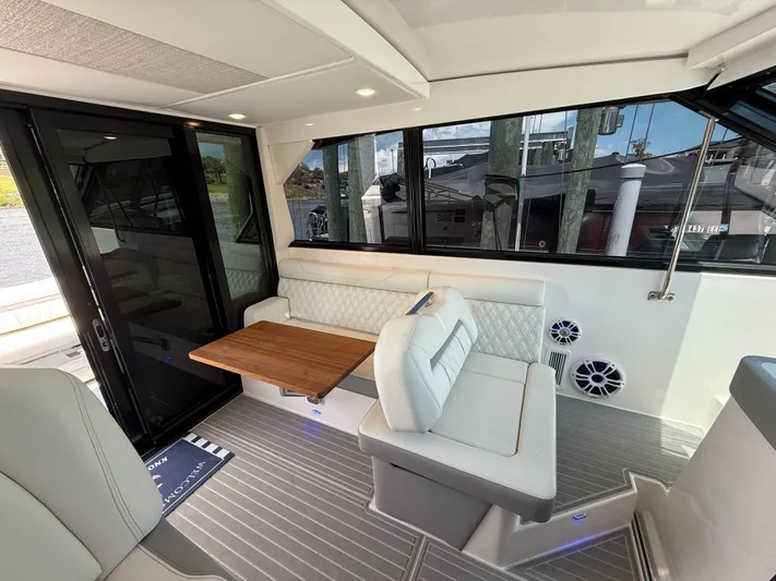  Yacht Photos Pics Interior of 2022 Regal 36 Grande Coupe with elegant seating and wooden table.