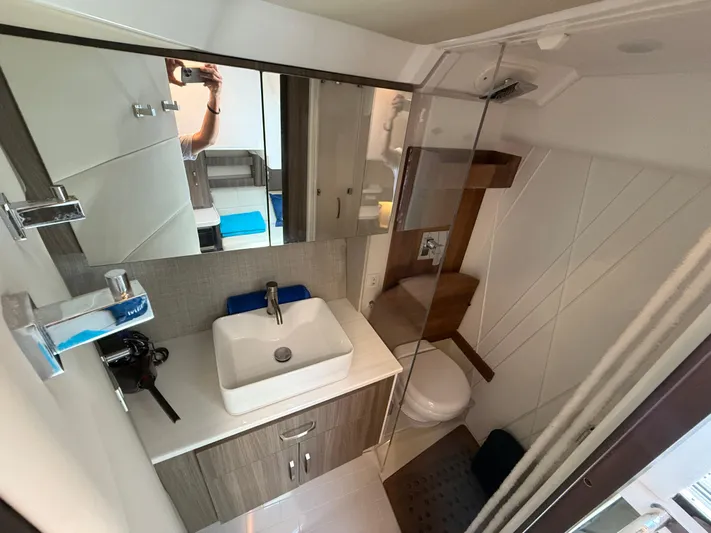  Yacht Photos Pics 2022 Regal 36 Grande Coupe bathroom with modern sink, mirror, and shower.