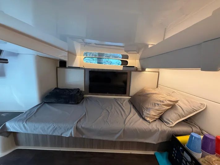  Yacht Photos Pics Interior cabin of 2022 Regal 36 Grande Coupe with bed and TV.