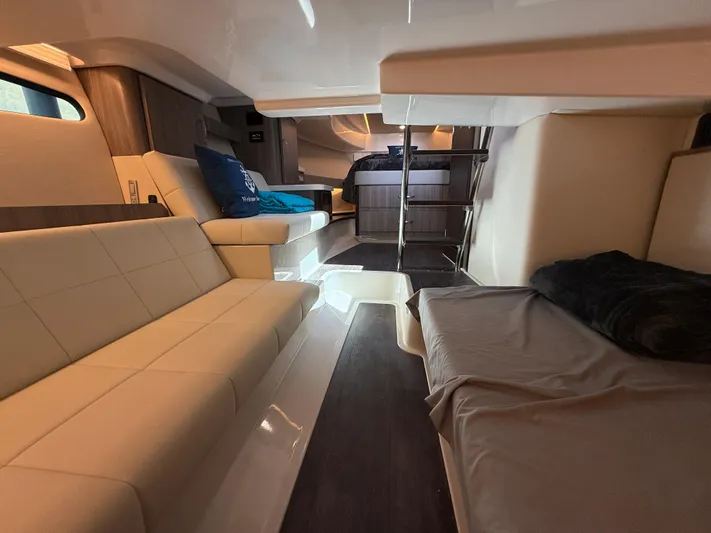  Yacht Photos Pics 2022 Regal 36 Grande Coupe interior with modern seating and cozy sleeping area.