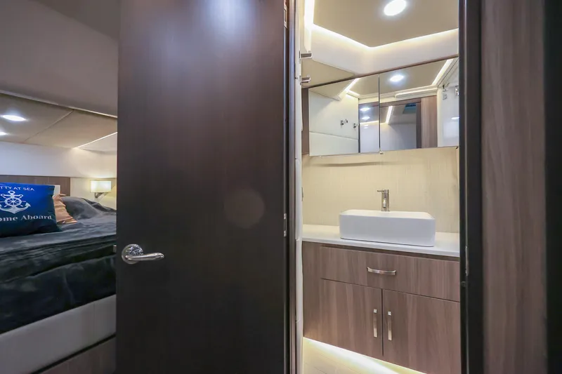  Yacht Photos Pics 2022 Regal 36 Grande Coupe interior with modern bathroom and cozy bedroom.