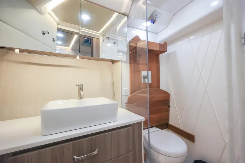  Yacht Photos Pics Modern bathroom interior of 2022 Regal 36 Grande Coupe yacht, featuring sleek sink and toilet.