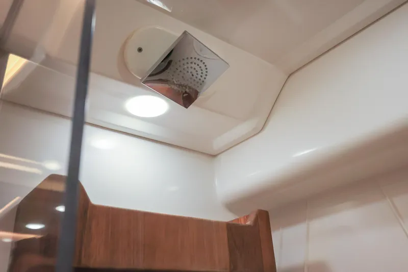  Yacht Photos Pics Interior of 2022 Regal 36 Grande Coupe, featuring modern showerhead and wooden accents.