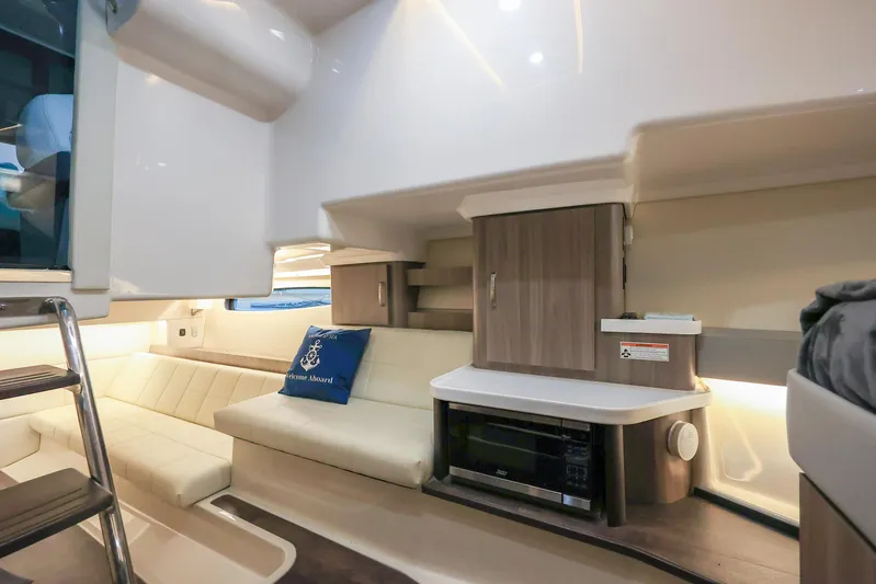  Yacht Photos Pics Interior of 2022 Regal 36 Grande Coupe yacht with modern seating and cabinetry.