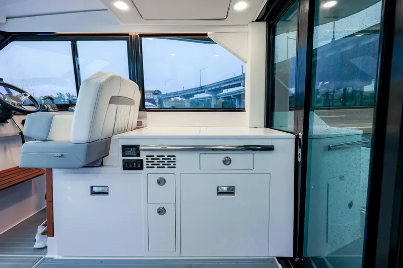  Yacht Photos Pics Interior of 2022 Regal 36 Grande Coupe, featuring helm seat and sleek cabinetry.