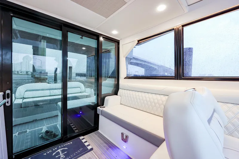  Yacht Photos Pics Luxurious interior of 2022 Regal 36 Grande Coupe yacht with plush seating and large windows.