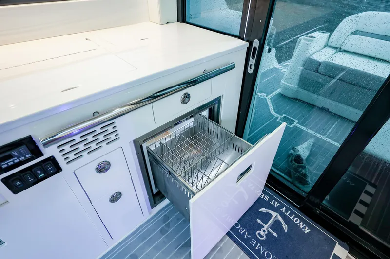  Yacht Photos Pics 2022 Regal 36 Grande Coupe yacht interior with open drawer and modern design.