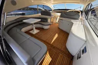 Luxurious 2001 Pershing 65 yacht interior with elegant seating and wooden flooring.