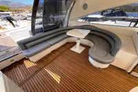 Luxurious seating area on 2001 Pershing 65 yacht with sleek design and wooden flooring.