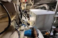 Engine room of a 2001 Pershing 65 yacht, showcasing machinery and wiring.