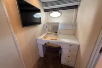 Vanity area in 2001 Pershing 65 yacht with TV, mirror, and drawers.