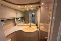 Luxurious bathroom interior of a 2001 Pershing 65 yacht, featuring elegant fixtures and lighting.