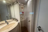 Bathroom interior of 2001 Pershing 65 yacht with sink and shower.