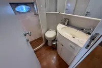 Bathroom interior of 2001 Pershing 65 yacht with sink, toilet, and shower.