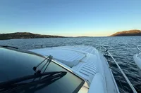 2001 Pershing 65 yacht cruising on serene waters at sunset.