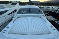 2001 Pershing 65 yacht docked, showcasing sleek design and spacious deck.