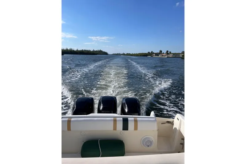 Summit Yacht Photos Pics 2004 Intrepid 377 Walkaround boat cruising on a sunny day, leaving a wake behind.